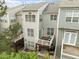 View of townhouse with decks and gray siding, offering outdoor living space at 703 Kirkeenan Cir, Morrisville, NC 27560