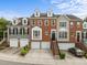View of townhomes with brick and siding facades, garages, and well-maintained lawns at 703 Kirkeenan Cir, Morrisville, NC 27560