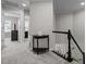 Upstairs hallway with carpet floors, black accent table and stairs at 703 Kirkeenan Cir, Morrisville, NC 27560