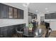 Eat-in kitchen featuring black cabinetry, white countertops and stainless steel appliances at 703 Kirkeenan Cir, Morrisville, NC 27560