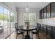 Eat-in kitchen with black cabinetry, white countertops, and sliding doors to the deck at 703 Kirkeenan Cir, Morrisville, NC 27560