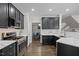 Modern kitchen with stainless steel appliances, white countertops, and black cabinetry at 703 Kirkeenan Cir, Morrisville, NC 27560