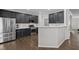 Modern kitchen featuring stainless steel appliances and dark cabinets and a contrasting breakfast bar at 703 Kirkeenan Cir, Morrisville, NC 27560
