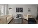Well-appointed living room featuring chic decor, stylish seating, hardwood floors, and large windows at 703 Kirkeenan Cir, Morrisville, NC 27560