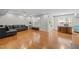 Spacious living room with hardwood floors, a modern black sofa, and a bright, open layout at 703 Kirkeenan Cir, Morrisville, NC 27560