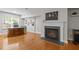 Bright living space with hardwood flooring, fireplace and large windows that provide natural light at 703 Kirkeenan Cir, Morrisville, NC 27560