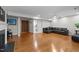 Spacious living room with hardwood floors, a fireplace, and a comfortable black sofa at 703 Kirkeenan Cir, Morrisville, NC 27560