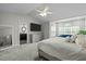 Spacious primary bedroom featuring a king bed, seating area, and ensuite bathroom at 703 Kirkeenan Cir, Morrisville, NC 27560