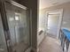 Bathroom featuring glass-enclosed shower, soaking tub, and open doorway leading to carpeted bedroom at 72 Ruskin Dr, Smithfield, NC 27577