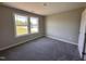 Bedroom with plush carpeting, neutral walls, and a window offering natural light and neighborhood views at 72 Ruskin Dr, Smithfield, NC 27577