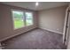Neutral bedroom features plush carpet, a double-window, and light gray walls at 72 Ruskin Dr, Smithfield, NC 27577