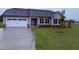 Charming single-story home with gray siding, a two-car garage, and well-manicured lawn at 72 Ruskin Dr, Smithfield, NC 27577