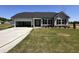 Charming single-story home with gray siding, black shutters, attached garage, and newly installed landscaping at 72 Ruskin Dr, Smithfield, NC 27577