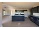 Modern kitchen with an island, stainless steel appliances, gray cabinets and countertops, and a view to the living room at 72 Ruskin Dr, Smithfield, NC 27577