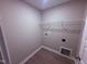 Small laundry room includes vinyl floors, and a shelf for storage above the hook-ups at 72 Ruskin Dr, Smithfield, NC 27577