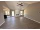 Bright living room featuring an electric fireplace, ceiling fan, wood floors, and many windows for natural lighting at 72 Ruskin Dr, Smithfield, NC 27577