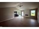 Open living area with light wood floors, ceiling fan, and connecting view into the kitchen at 72 Ruskin Dr, Smithfield, NC 27577