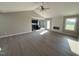 Bright open-concept living room with vaulted ceiling, modern fireplace, and wood-look flooring at 72 Ruskin Dr, Smithfield, NC 27577