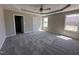 Spacious main bedroom with plush carpeting, a ceiling fan, and many windows providing natural lighting at 72 Ruskin Dr, Smithfield, NC 27577