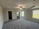 Spacious primary bedroom features a tray ceiling, carpet, and an ensuite bathroom at 72 Ruskin Dr, Smithfield, NC 27577
