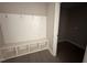 Mud room entry with built-in bench, coat hooks, storage cubbies, and adjoining laundry room at 72 Ruskin Dr, Smithfield, NC 27577