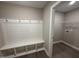 Mudroom with built-in bench, coat hooks and view into the laundry room at 72 Ruskin Dr, Smithfield, NC 27577