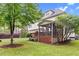 A beautiful backyard view with a wooden screened porch extending from the house at 7321 Clarincarde Ct, Wake Forest, NC 27587
