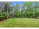 Expansive backyard with mature trees provides ample space for outdoor activities and entertaining at 7321 Clarincarde Ct, Wake Forest, NC 27587