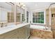 Bright primary bath with a double sink vanity, soaking tub, and tiled shower at 7321 Clarincarde Ct, Wake Forest, NC 27587