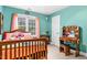 Inviting bedroom featuring a wooden bed frame, colorful accents, and a vanity with Hollywood style lighting at 7321 Clarincarde Ct, Wake Forest, NC 27587
