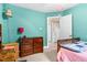 Comfortable bedroom with turquoise walls, a dresser, and a doorway leading to other rooms in the house at 7321 Clarincarde Ct, Wake Forest, NC 27587