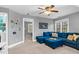 Bright bonus room with neutral walls, a comfortable blue sectional couch and open doorway at 7321 Clarincarde Ct, Wake Forest, NC 27587