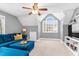 Well-lit bonus room featuring neutral walls, a ceiling fan and a comfortable blue sectional couch at 7321 Clarincarde Ct, Wake Forest, NC 27587
