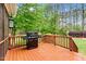 Outdoor deck with grill, overlooking the backyard and lush trees at 7321 Clarincarde Ct, Wake Forest, NC 27587