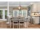 Inviting dining area with a chandelier and views into the kitchen and sun room at 7321 Clarincarde Ct, Wake Forest, NC 27587