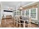 Charming dining area with a view of the sun room, kitchen, and large windows at 7321 Clarincarde Ct, Wake Forest, NC 27587