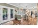 Open dining area with French doors leading to a deck and a view of the kitchen at 7321 Clarincarde Ct, Wake Forest, NC 27587