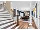 Elegant dining room with blue walls and white pillars, view from hardwood staircase at 7321 Clarincarde Ct, Wake Forest, NC 27587