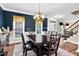 Formal dining room featuring a dark wood table, blue accent wall, and hardwood floors at 7321 Clarincarde Ct, Wake Forest, NC 27587