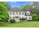 Classic two-story home featuring a well-kept lawn, lush landscaping, and a charming entryway at 7321 Clarincarde Ct, Wake Forest, NC 27587