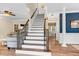 Elegant foyer with hardwood floors, staircase, and view into the dining and living areas at 7321 Clarincarde Ct, Wake Forest, NC 27587