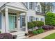 Charming front porch entrance with a light blue door, well maintained landscaping at 7321 Clarincarde Ct, Wake Forest, NC 27587