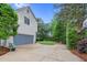 View of the garage and driveway leading to a large backyard with ample green space at 7321 Clarincarde Ct, Wake Forest, NC 27587