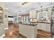Open kitchen with granite island and counters, hardwood floors and sunny breakfast nook at 7321 Clarincarde Ct, Wake Forest, NC 27587
