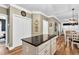 Bright kitchen with granite counters, a large island, hardwood floors, and crisp white cabinets at 7321 Clarincarde Ct, Wake Forest, NC 27587
