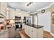 Bright kitchen with granite counters, an island, stainless appliances, and wood-look floors at 7321 Clarincarde Ct, Wake Forest, NC 27587