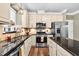 Well-equipped kitchen with stainless steel appliances, granite countertops, and a breakfast bar at 7321 Clarincarde Ct, Wake Forest, NC 27587