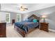 Spacious main bedroom featuring neutral walls, plush carpet and large windows with leafy green views at 7321 Clarincarde Ct, Wake Forest, NC 27587