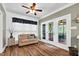 Bright sun room with a cozy couch, large windows, and French doors leading to the deck at 7321 Clarincarde Ct, Wake Forest, NC 27587
