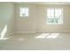 Bright bedroom with neutral carpet, natural light, and fresh paint, creating a serene space at 737 W Holly Springs Rd, Holly Springs, NC 27540
